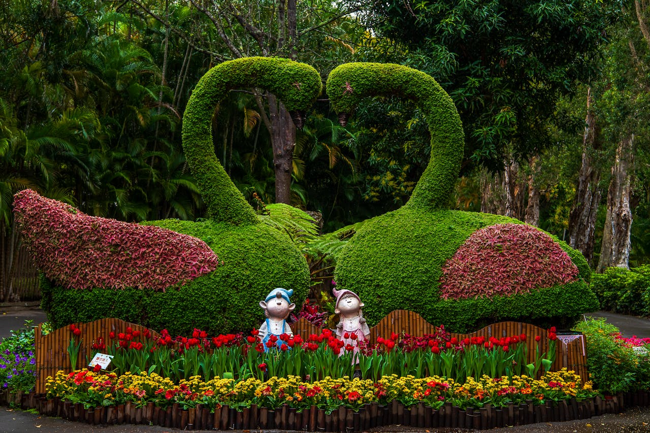 Creative Swan Plant Sculptures and Flower Beds in a Park